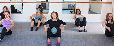 Sitting on floor squeezing balls